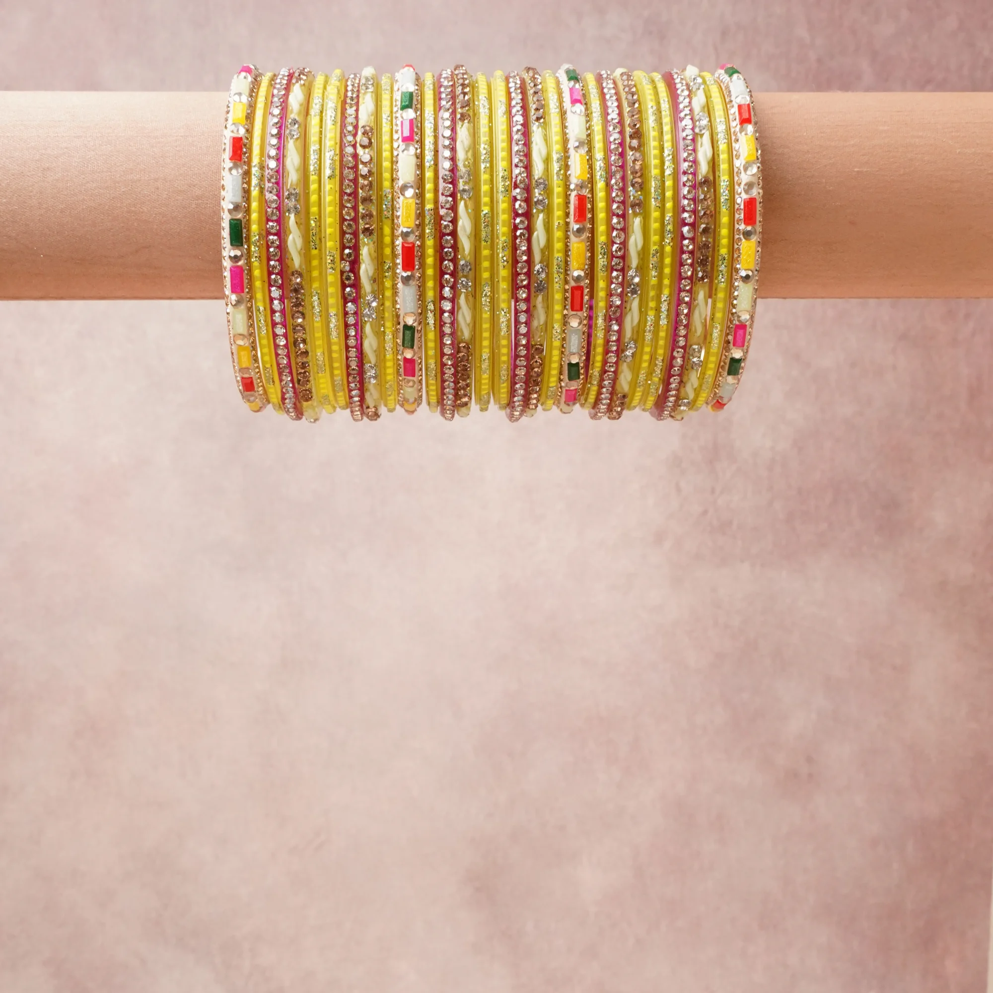 A grounding Lemon Yellow forms the heart of the set, while touches of Maroon, Fuchsia, Emerald Green, Scarlet Red, Aqua Blue, Cream, Clear, Gold add charm.

A thoughtful composition of Glass, Metal Alloy, Rhinestones, Textile, Enamel, designed to feel complete without being heavy.
Each element layers seamlessly, creating a look that is refined, wearable and quietly striking.